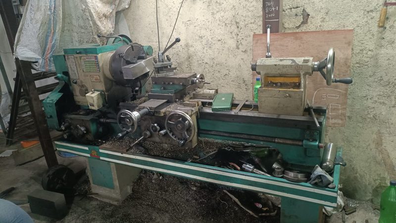 Centre lathe with a three-jaw chuck, set up for a round component.
