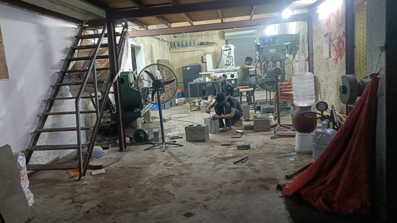 The fitting area: mould blocks being worked by hand, with the grinding section at the back of the shop.